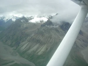 view from the plane flying through Lake Clark Pass witnessing a volcanic activity close-up