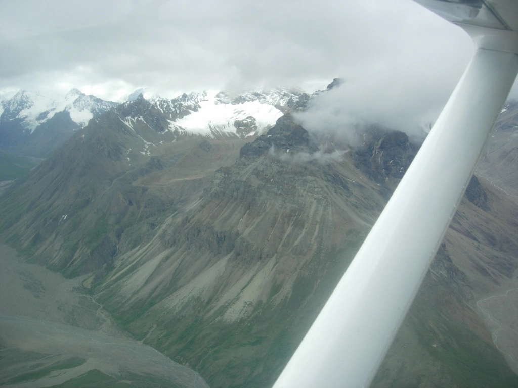 view from the plane flying through Lake Clark Pass witnessing a volcanic activity close-up